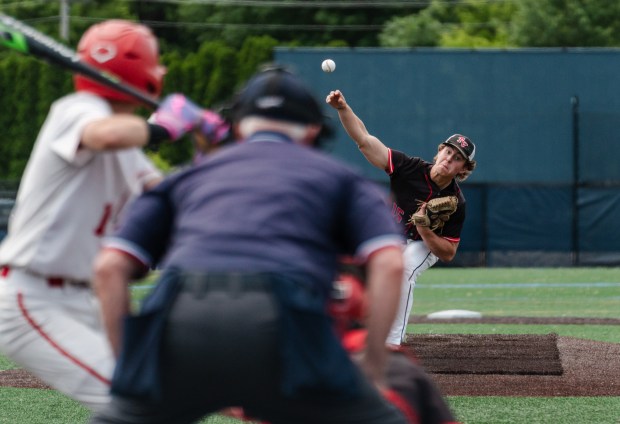 Tri-Valley junior Gavin Klock (15) delivers a pitch as Tri-Valley...