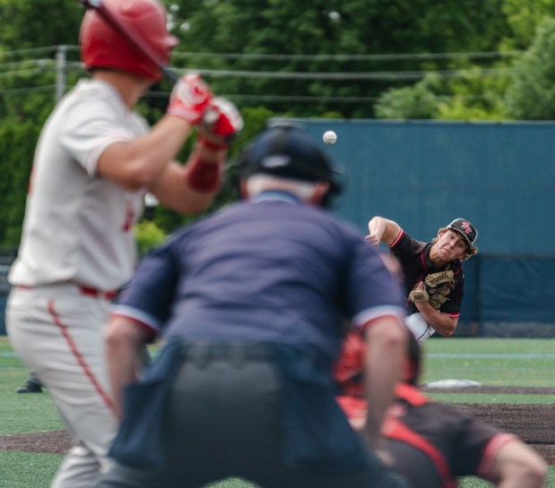 Tri-Valley junior Gavin Klock (15) delivers a pitch as Tri-Valley...