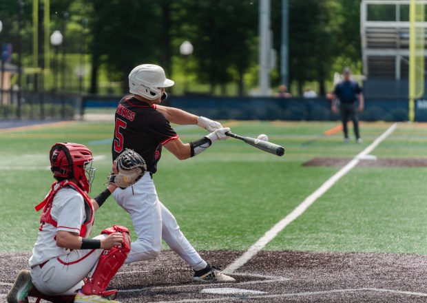 Tri-Valley freshman Parker Hatter (5) connects with the ball as...