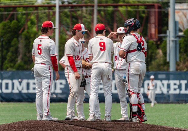 The Holy Redeemer baseball team meets at the mound as...