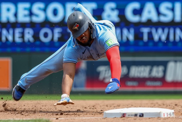 Vladimir Guerrero Jr. #27 of the Toronto Blue Jays slides safely into third base in the third inning against the Minnesota Twins at Target Field on June 8, 2025 in Minneapolis, Minnesota. (Photo by Ellen Schmidt/Getty Images)