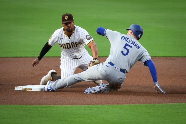 San Diego Padres' Xander Bogaerts attempts to tag out Los Angeles Dodgers' Freddie Freeman at Petco Park on Monday, June 9, 2025 in San Diego, CA. (Meg McLaughlin / The San Diego Union-Tribune)