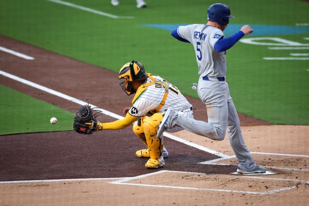 Los Angeles Dodgers' Freddie Freeman scores a run against San Diego Padres' Elias Diaz at Petco Park on Monday, June 9, 2025 in San Diego, CA. (Meg McLaughlin / The San Diego Union-Tribune)