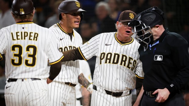 San Diego Padres' Manny Machado and Mike Shildt argue with home plate umpire Mike Estabrook during the tenth inning against the Los Angeles Dodgers at Petco Park on Monday, June 9, 2025 in San Diego, CA. (Meg McLaughlin / The San Diego Union-Tribune)