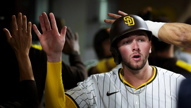 San Diego Padres' Jackson Merrill is welcomed back into the dugout after scoring a run during the sixth inning against the Los Angeles Dodgers at Petco Park on Tuesday, June 10, 2025 in San Diego, CA. (Meg McLaughlin / The San Diego Union-Tribune)