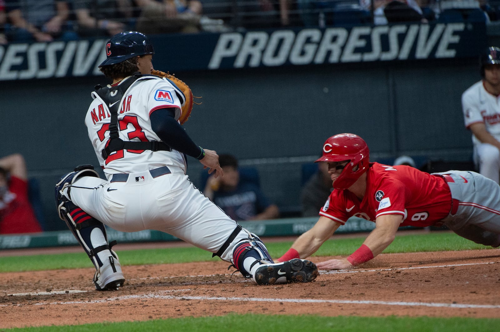 Cincinnati Reds' Matt McClain, right, is out at home plate as Cleveland Guardians' Bo Naylor 923) applies the tag in time during the eighth inning of a baseball game, Tuesday, June 10, 2025, in Cleveland. (AP Photo/Phil Long)