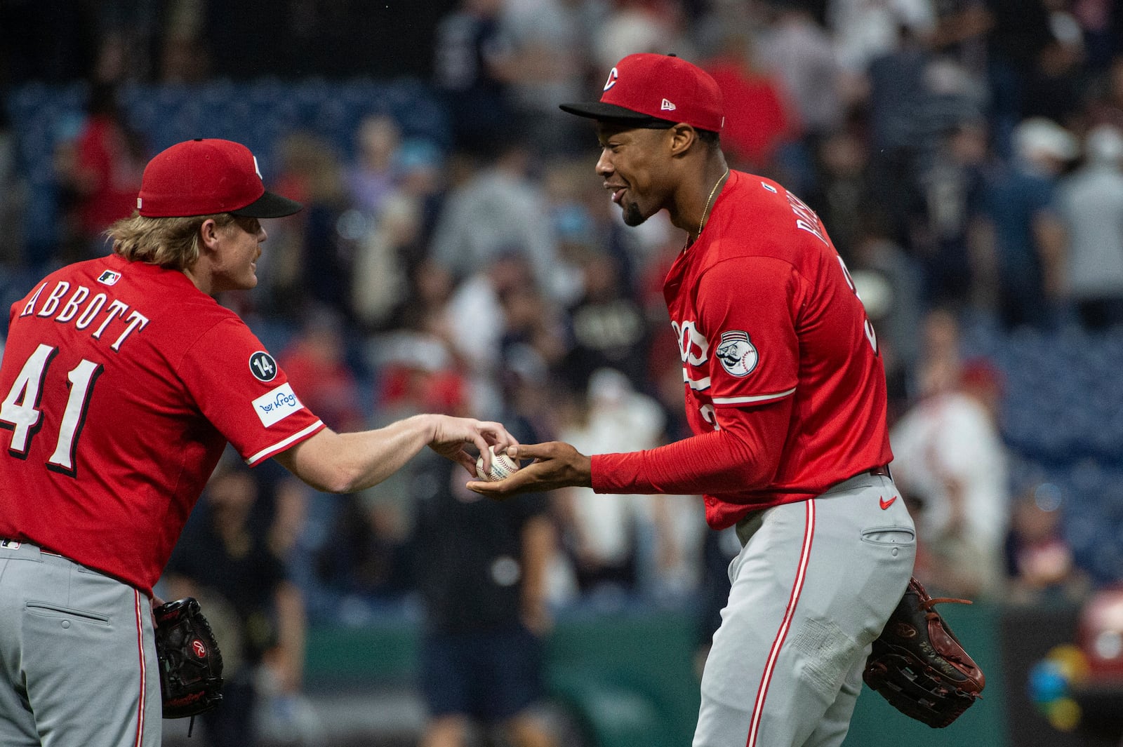 Cincinnati Reds starting pitcher Andrew Abbott (41) accepts the final out baseball from Will Benson, right, after the team's win over the Cleveland Guardians at the end of a baseball game, Tuesday, June 10, 2025, in Cleveland. (AP Photo/Phil Long)