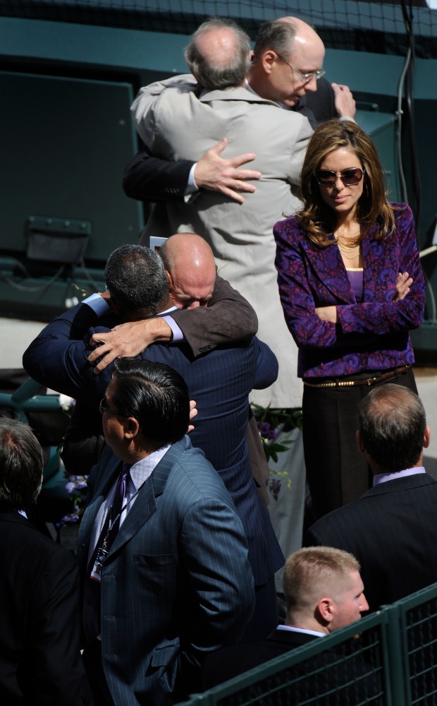 Rockies owner Charlie Monfort sobs as he hugs an unidentified man before the memorial service for Rockies President Keli McGregor at Coors Field in Denver, April 25, 2010. His wife, Vanessa Monfort, stands just behind him to the right. (Photo by Judy DeHaas/The Denver Post)
