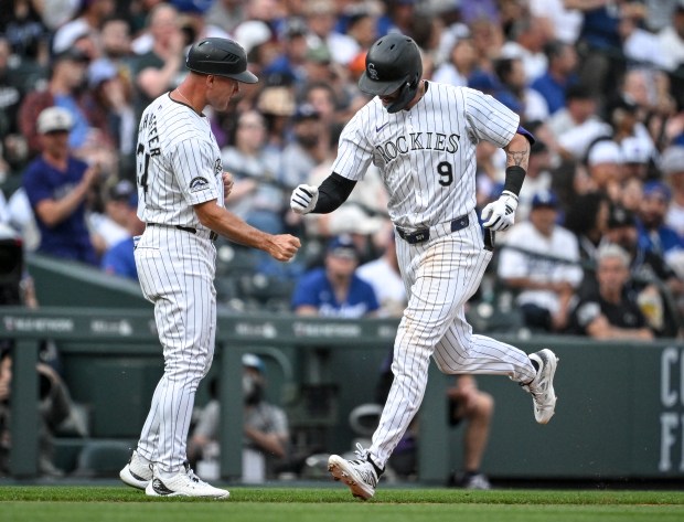 Brenton Doyle (9) of the Colorado Rockies celebrates hitting a solo home run off of Walker Buehler (21) of the Los Angeles Dodgers with third base coach Warren Schaeffer (34) during the fourth inning at Coors Field in Denver on Tuesday, June 18, 2024. (Photo by AAron Ontiveroz/The Denver Post)