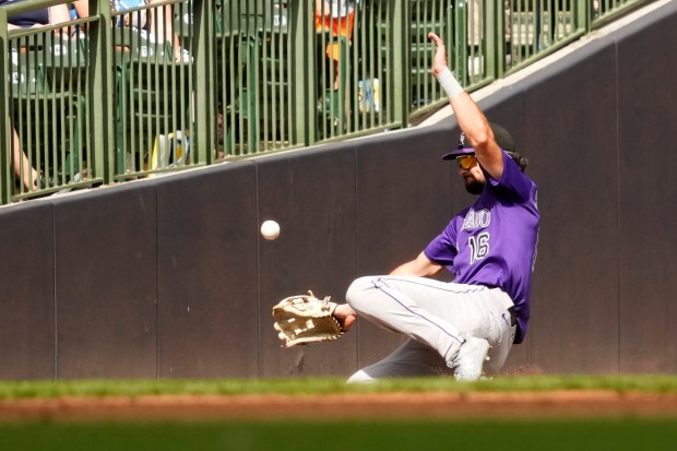 Colorado Rockies outfielder Sam Hilliard misses a ball hit by Milwaukee Brewers' Brice Turang during the third inning of a baseball game Saturday, June 28, 2025, in Milwaukee. (AP Photo/Kayla Wolf)