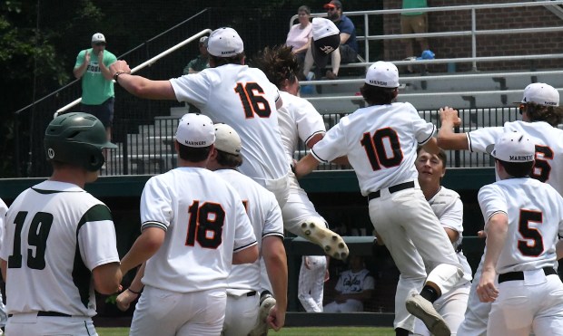 The Marine City Mariners celebrate after they beat Olivet, 8-5,...