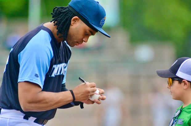 Thunder first baseman Carsten Sabathia signs an autograph for a...