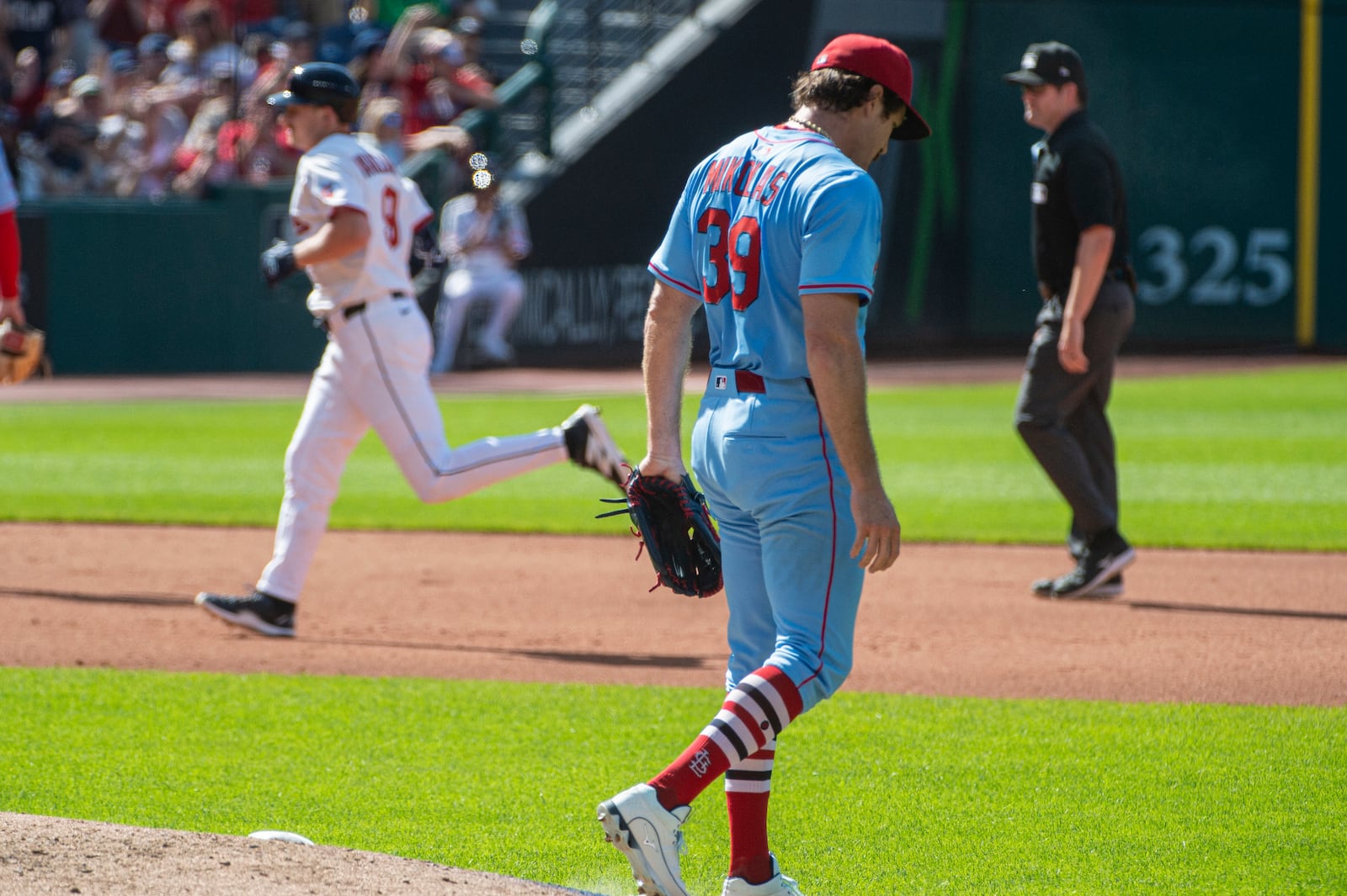 St. Louis Cardinals starting pitcher Miles Mikolas steps off the mound after giving up a solo home run to Cleveland Guardians' Kyle Manzardo, rear, during the fourth inning of a baseball game, Saturday, June 28, 2025, in Cleveland. (AP Photo/Phil Long)