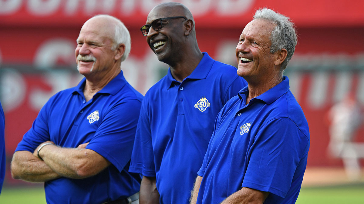 Former Kansas City Royals players Dennis Leonard (left), Willie Wilson (center) and George Brett (right) look on, prior to a celebration for the 50th year of Royals baseball, before a game against the St. Louis Cardinals at Kauffman Stadium.