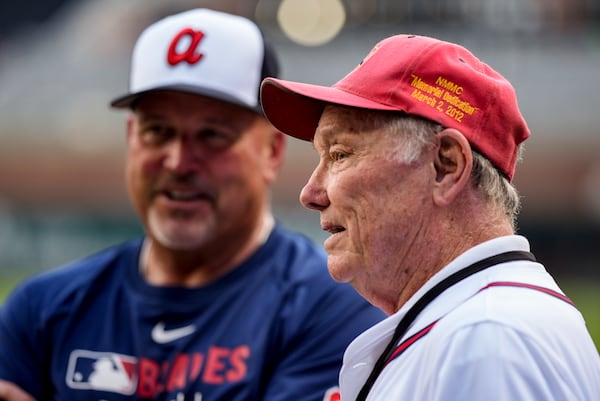 Former U.S. Marine and Atlanta Braves player Chuck Goggin (right) speaks to players before Friday's game between the Braves and Colorado Rockies in Atlanta. (Mike Stewart/AP)