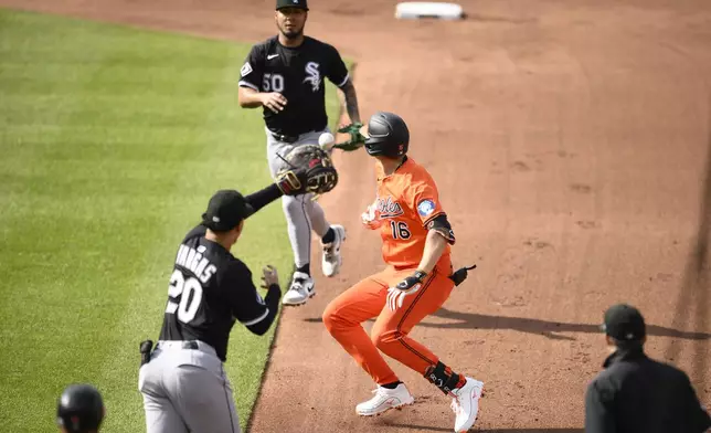 Baltimore Orioles' Coby Mayo (16) is caught in a rundown by Chicago White Sox first baseman Miguel Vargas (20) and second baseman Lenyn Sosa (50) during the fourth inning of a baseball game, Saturday, May 31, 2025, in Baltimore. (AP Photo/Nick Wass)