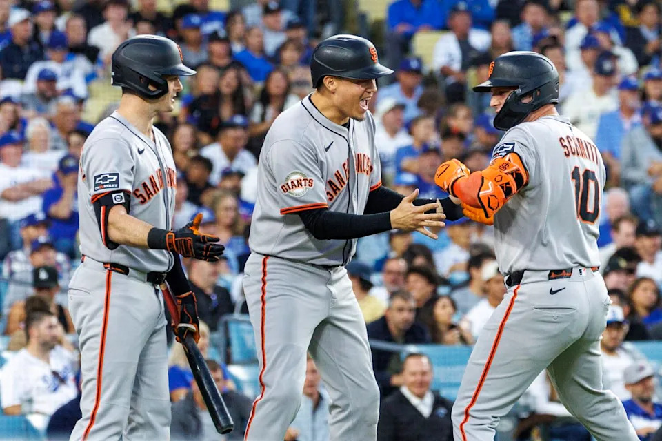 San Francisco's Casey Schmitt, right, celebrates with Wilmer Flores, center, and Mike Yastrzemski.