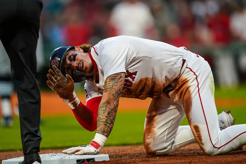 Boston Red Sox outfielder Jarren Duran (16) after sliding into third base against the Tampa Bay Rays in the third inning at Fenway Park.David Butler II-Imagn Images