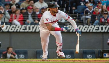 Cleveland Guardians' Jose Ramirez throws to first base but not in time to put out Los Angeles Angels' Logan O'Hoppe during the seventh inning of a baseball game, Friday, May 30, 2025, in Cleveland.