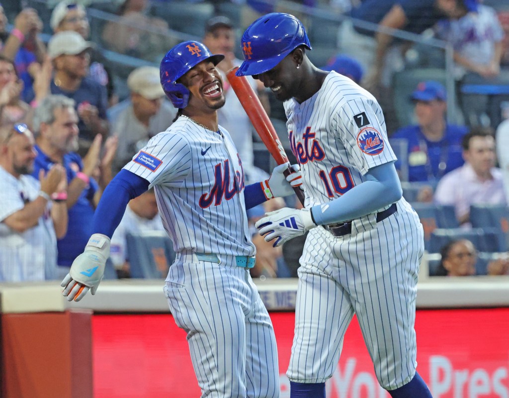 New York Mets players Ronny Mauricio and Francisco Lindor celebrating a home run.