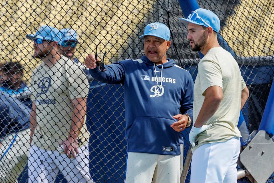 Dodgers manager Dave Roberts chats with outfielder Michael Conforto during batting practice.