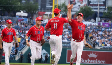 Rep. August Pfluger, R-Texas, is congratulated by Sen. Eric Schmitt, R-Mo., after a play in the first inning of the Congressional Baseball Game at Nationals Park on Wednesday.