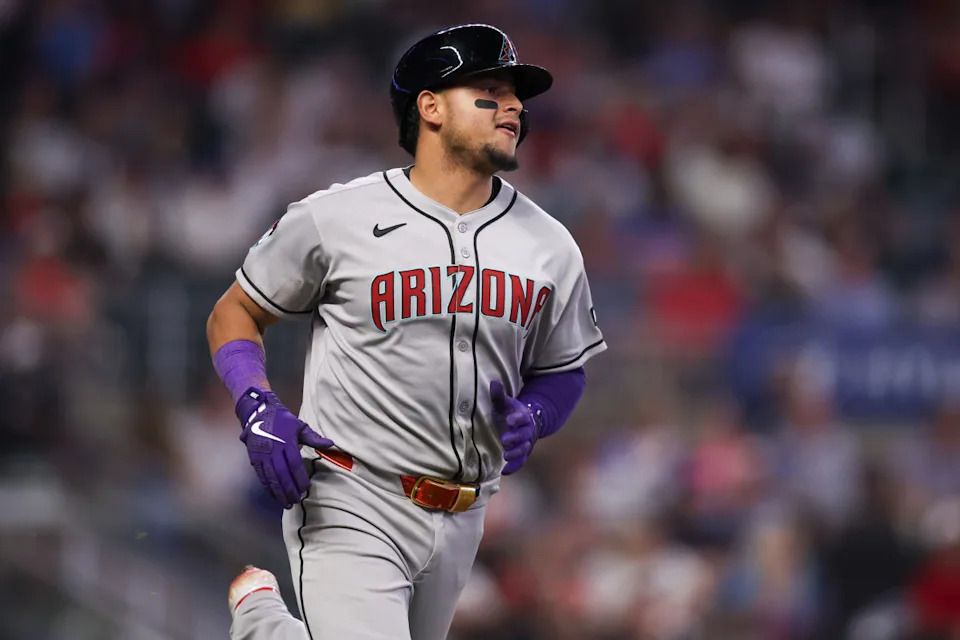 Jun 3, 2025; Atlanta, Georgia, USA; Arizona Diamondbacks catcher Gabriel Moreno (14) hits a single against the Atlanta Braves in the ninth inning at Truist Park.© Brett Davis-Imagn Images