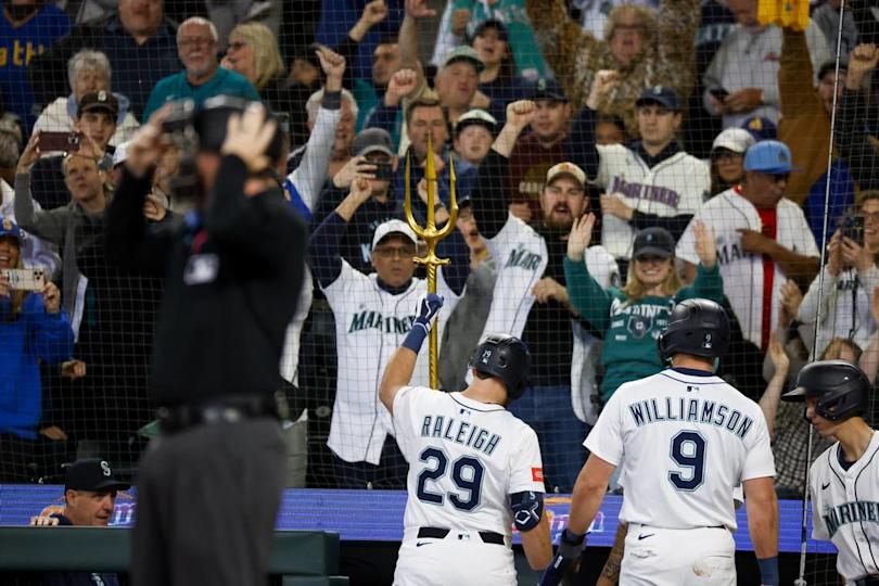May 31, 2025; Seattle, Washington, USA; Seattle Mariners fans cheer as designated hitter Cal Raleigh (29) raises the home run trident following his two-run home run against the Minnesota Twins during the third inning at T-Mobile Park. Joe Nicholson/USA TODAY NETWORK