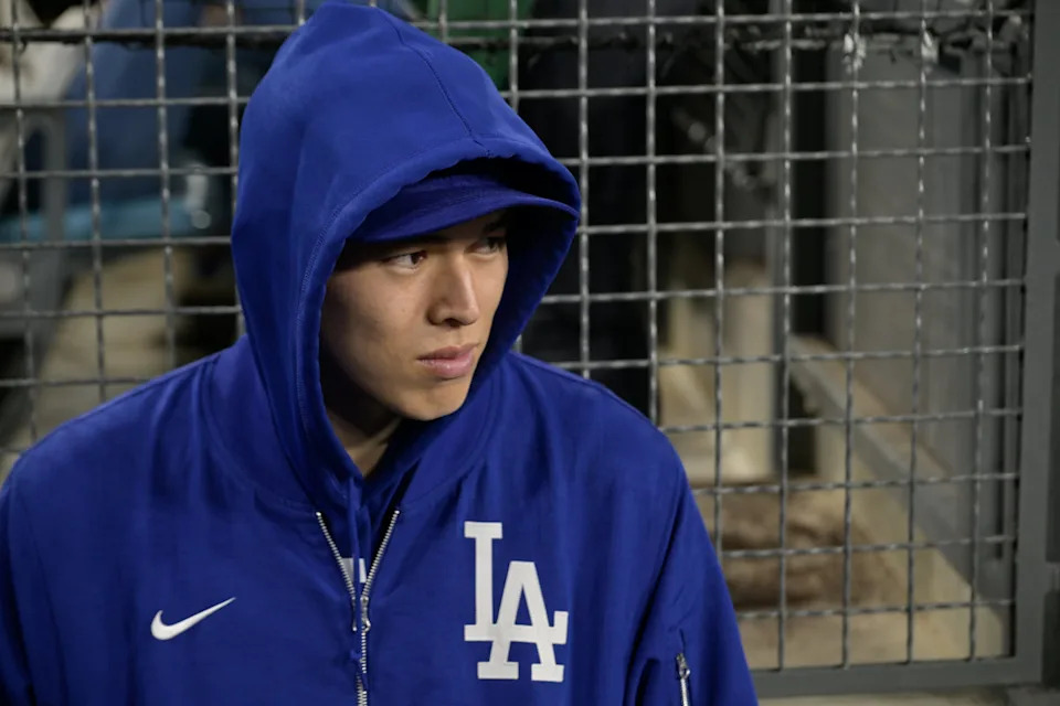 Los Angeles Dodgers pitcher Roki Sasaki (11) looks on in the dugout during the third inning of the game against the Athletics at Dodger StadiumJayne Kamin-Oncea-Imagn Images