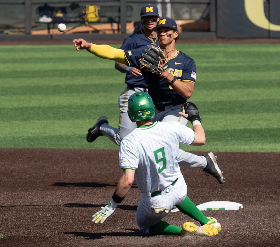 Michigan’s Mitch Voit gets the force out at second against Oregon’s Maddox Molony during the 4th inning.