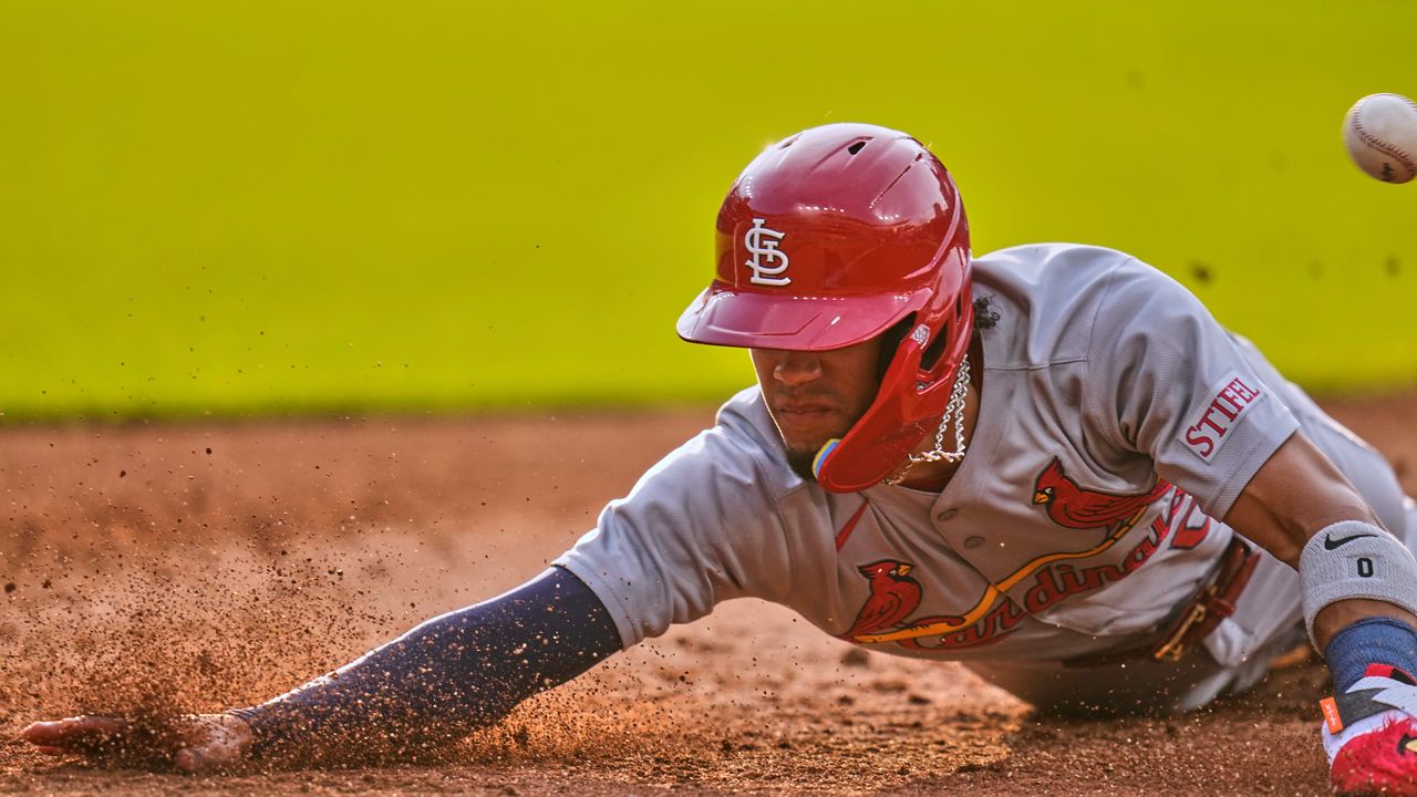 St. Louis Cardinals' Masyn Winn dives back into first base as the ball gets away from Cleveland Guardians first baseman Kyle Manzardo on a pickoff-attempt in the third inning of a baseball game in Cleveland, Friday, June 27, 2025.