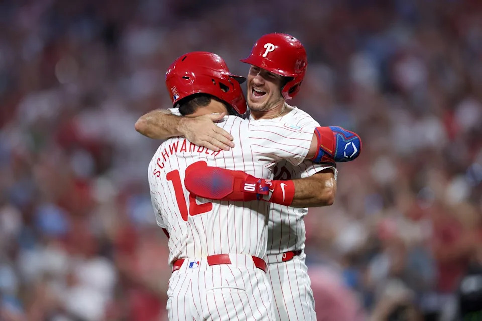 Philadelphia Phillies designated hitter Kyle Schwarber (12) celebrates with catcher J.T. Realmuto (10) after hitting a four RBI grand slam during the fourth inning against the Miami Marlins at Citizens Bank Park.Bill Streicher-USA TODAY Sports