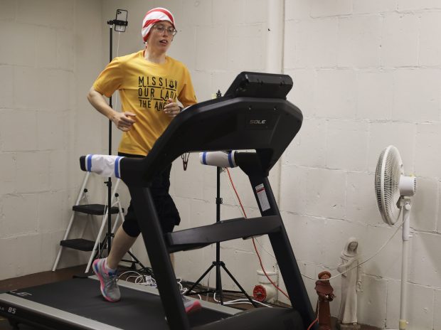 Sr. Stephanie Baliga, of the Mission of Our Lady of Angels, jogs on her tread mill as she prepares for a virtual marathon, Aug. 19, 2020. ( Abel Uribe/Chicago Tribune)