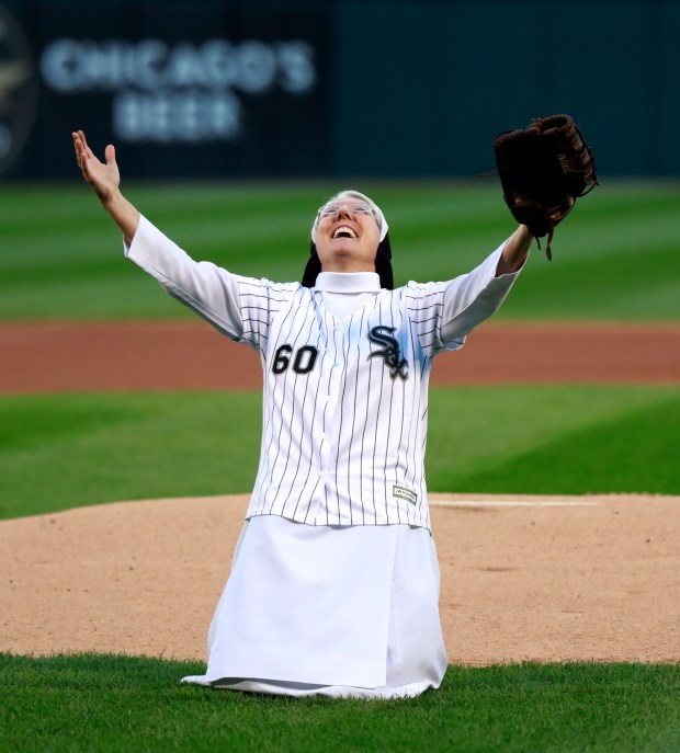 Sr. Mary Jo Sobieck drops to her knees after her ceremonial first pitch before the start of a game between the Cubs and the White Sox at Guaranteed Rate Field in Chicago on Sept. 22, 2018. (Nuccio DiNuzzo/Chicago Tribune)