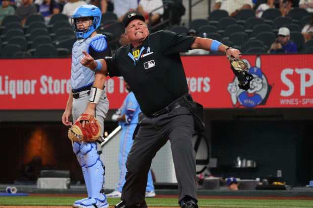 Umpire Marvin Hudson ejects White Sox manager Will Venable (not shown) as catcher Kyle Teel looks on during the first inning against the Rangers on Sunday, June 15, 2025, in Arlington, Texas. (AP Photo/LM Otero)