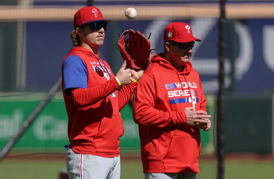 Philadelphia Phillies shortstop Bryson Stott (5) stands on the field with manager Rob Thomson during World Series workouts at Minute Maid Park.Troy Taormina-Imagn Images