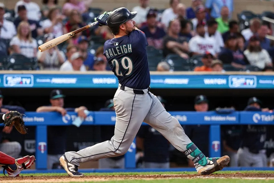 Seattle Mariners’ Cal Raleigh hits a solo home run against the Minnesota Twins during the ninth inning of baseball game Monday, June 23, 2025, in Minneapolis. (AP Photo/Matt Krohn)