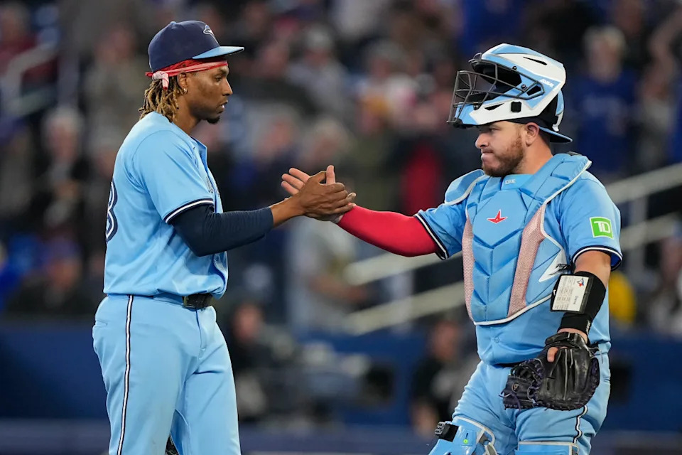 Ex-Blue Jays pitcher Jose Urenas joins hands with catcher Alejandro Kirk on May 29. © John E. Sokolowski-Imagn Images