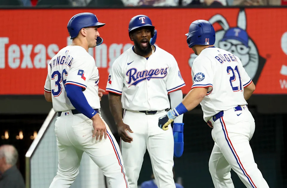 Texas Rangers first baseman Jake Burger (21) celebrates with Texas Rangers left fielder Wyatt Langford (36) and Texas Rangers right fielder Adolis Garcia (53) after hitting a three-run home run during the first inning against the Tampa Bay Rays at Globe Life Field.Kevin Jairaj-Imagn Images