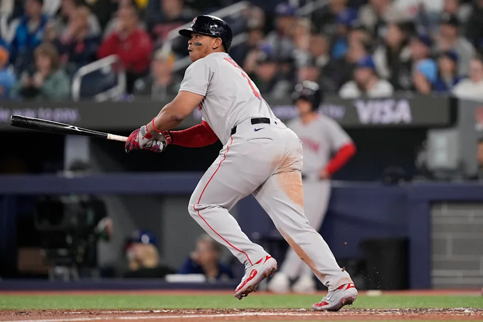 Boston Red Sox designated hitter Rafael Devers (11) hits an RBI double against the Toronto Blue Jays.John E. Sokolowski-Imagn Images