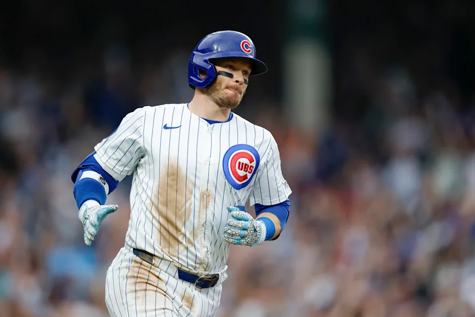 Chicago Cubs outfielder Ian Happ (8) rounds the bases after hitting a grand slam at Wrigley Field.Kamil Krzaczynski-Imagn Images