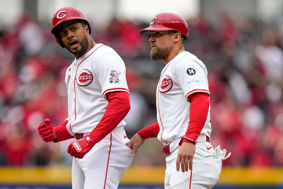 Jeimer Candelario celebrates a run-scoring single in the season opener (with first base coach Collin Cowgill). Candelario has been on the injured list since the end of April and is set to join the Reds in Cincinnati on Monday.