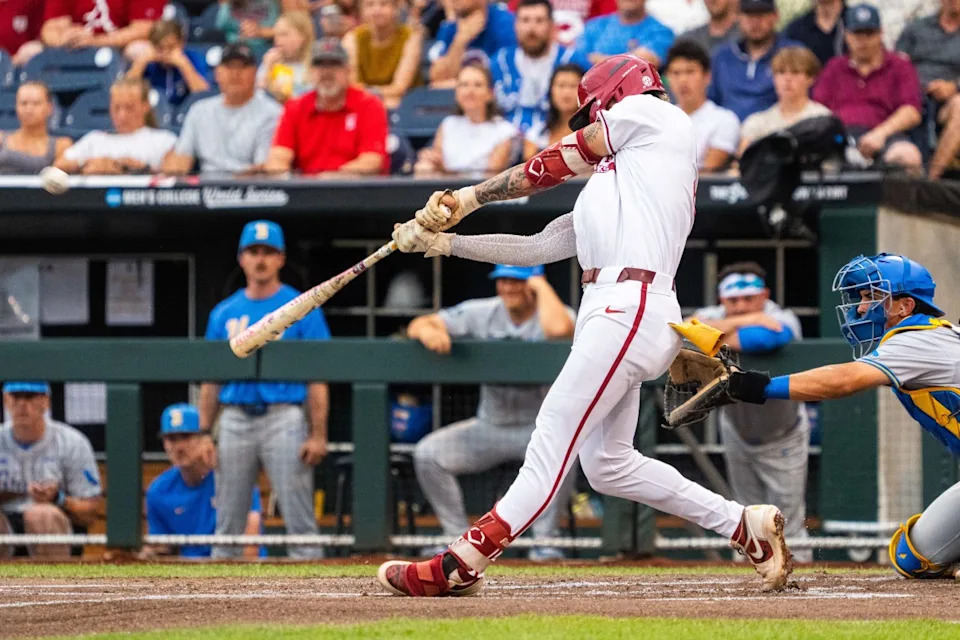 Arkansas Razorbacks shortstop Wehiwa Aloy (9) hits a two-run home run against the UCLA Bruins during the first inning at Charles Schwab Field.Dylan Widger-Imagn Images