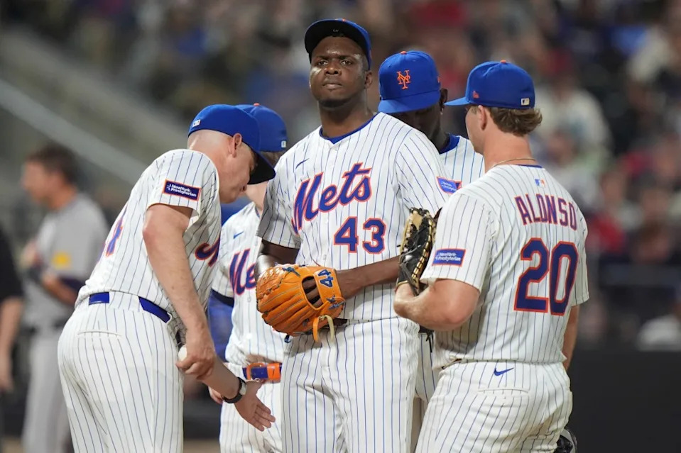 Mets manager Carlos Mendoza takes the ball from New York Mets pitcher Huascar Brazobán during the sixth inning of a baseball game against the Atlanta Braves Tuesday, June 24, 2025. AP
