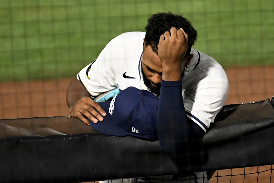 Tampa Bay Rays third baseman Junior Caminero reacts as pitcher Hunter Bigge (43) gets medical attention after getting hit in the face by a foul ball.