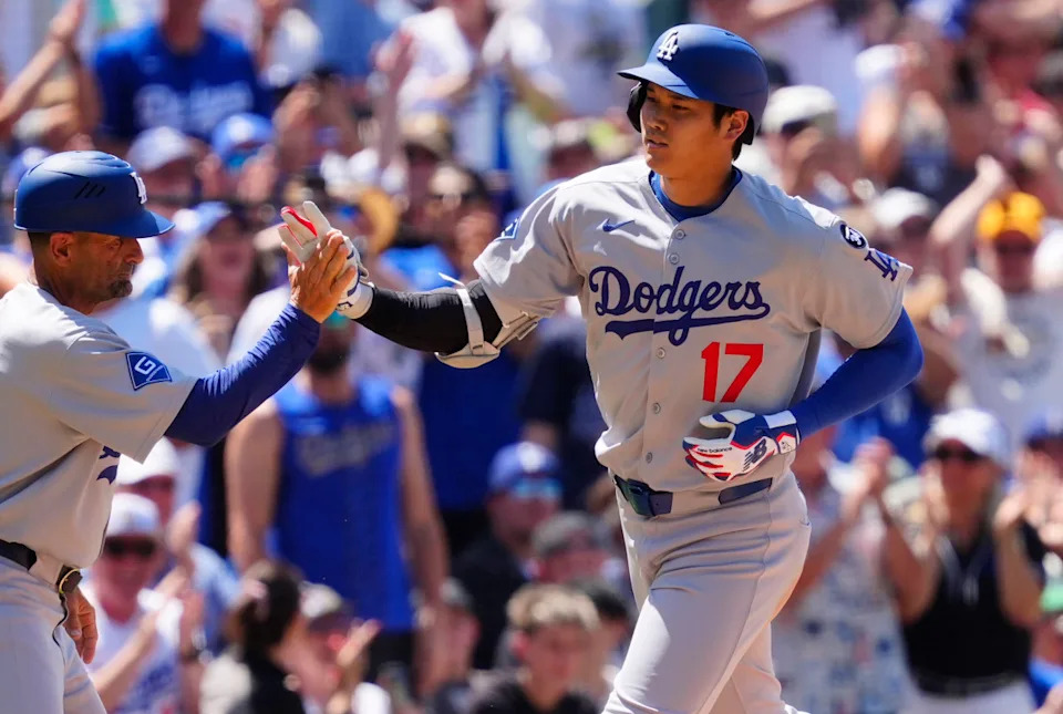 Jun 26, 2025; Denver, Colorado, USA; Los Angeles Dodgers third base coach Dino Ebel (91) congratulates Los Angeles Dodgers designated hitter Shohei Ohtani (17) after his solo home run in the seventh inning at Coors Field. Ron Chenoy-Imagn Images