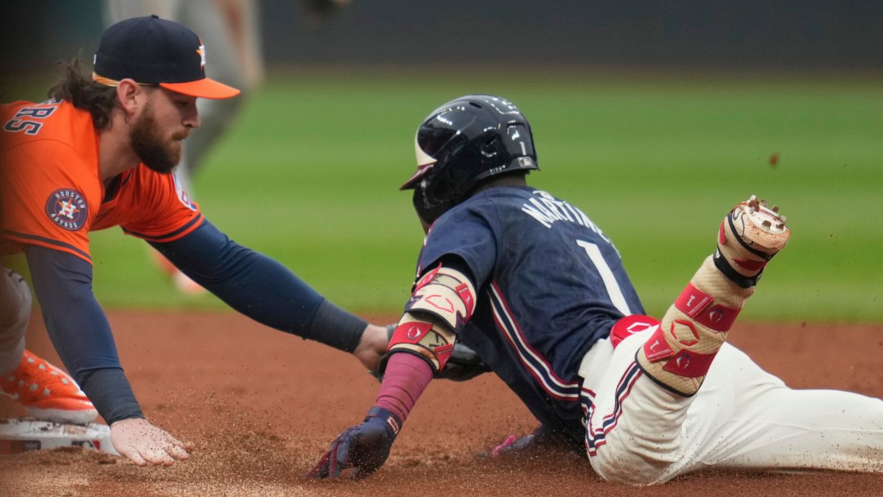 Houston Astros second baseman Brendan Rodgers, left, tags out Cleveland Guardians' Angel Martinez (1) at second base in the first inning of a baseball game in Cleveland, Friday, June 6, 2025.