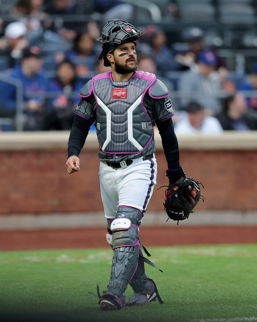 New York Mets catcher Luis Torrens walking on the field.