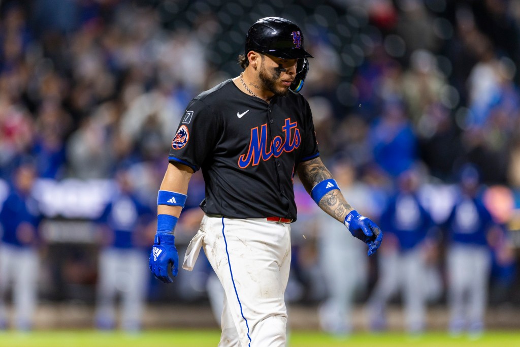 New York Mets player Francisco Alvarez walks off the field.