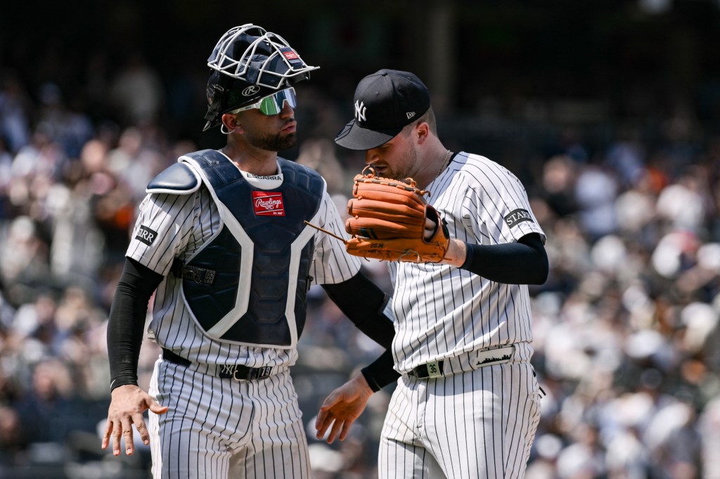 J.C. Escarra (L.) talks with Clarke Schmidt during the Yankees-Orioles game on June 21, 2025. 
